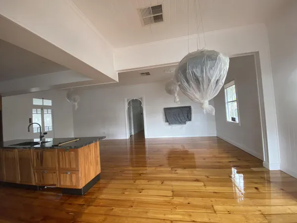 Golden timber floor through a kitchen and adjoining living room