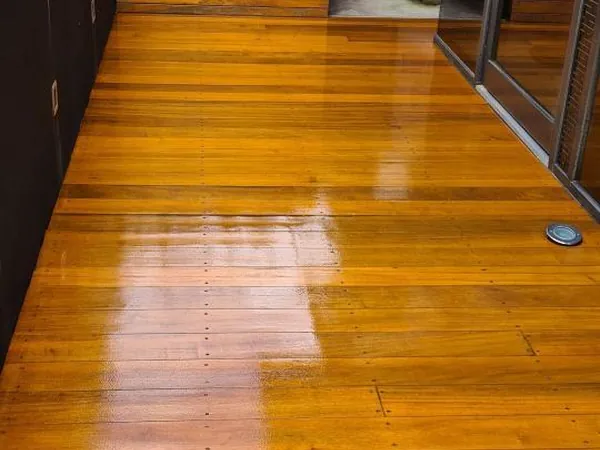 Glossy golden timber walkway and steps in an outdoor entry area