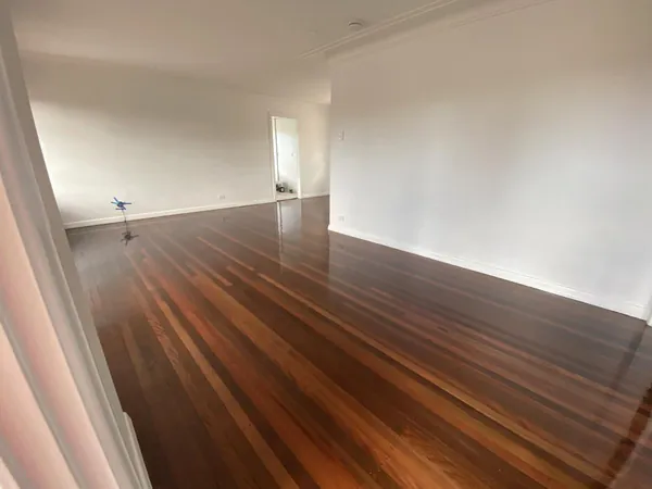 Long polished timber floor in a spacious empty living room