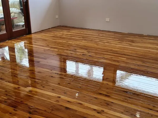 Golden polished floorboards beside glass doors and white walls